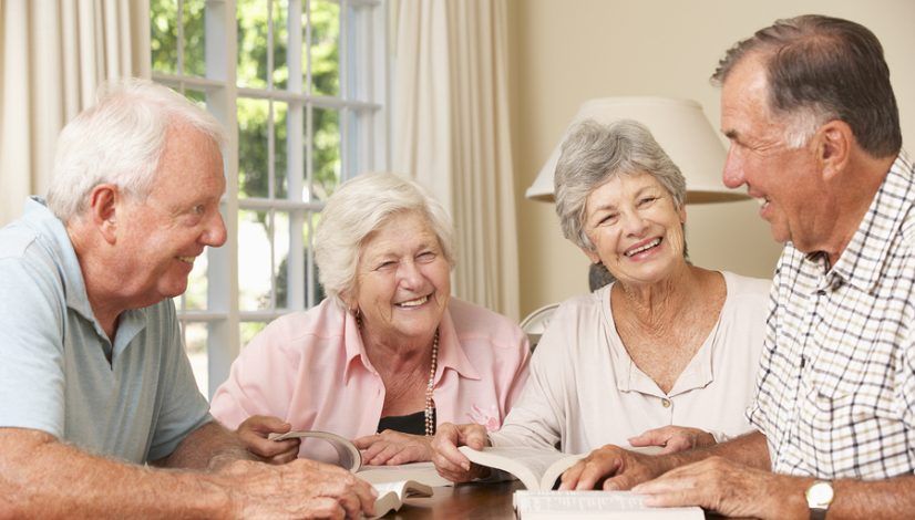 Group Of Senior Couples Attending Book Reading Group